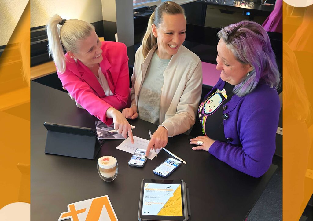 drei Frauen in einem Büro mit Tablet Handy und Kaffee